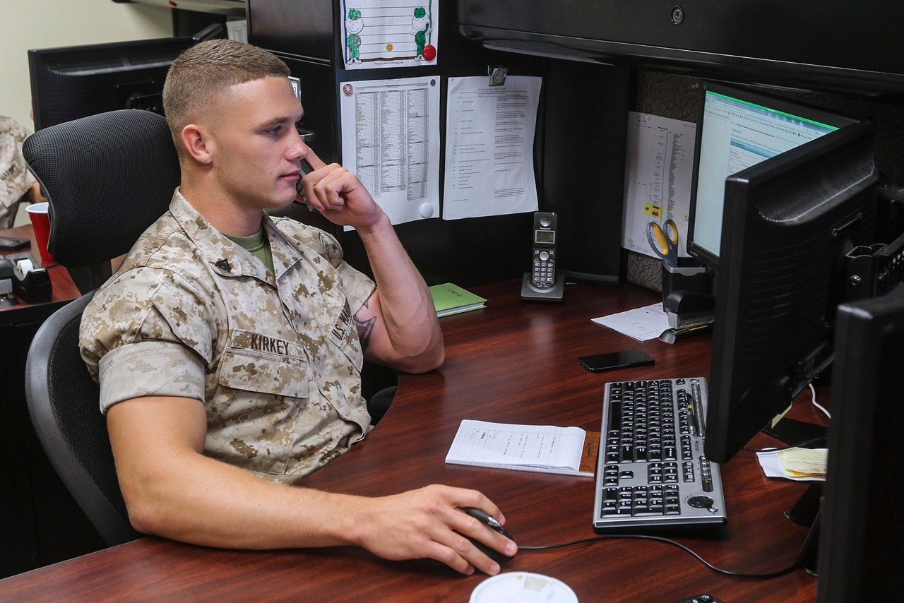 A financial resource management analyst works at his desk in the comptroller office.